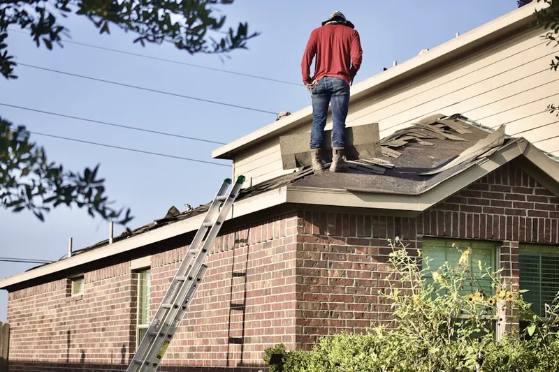 Professional roofer working on a residential roof in Bergen Point